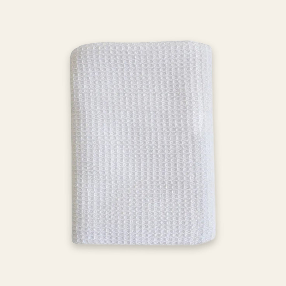 A white textured fabric pouch or sleeve with a waffle-like pattern, shown flat against a solid cream background.
