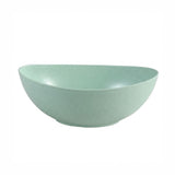 A light mint green ceramic bowl with a subtle speckled texture, shown from a side angle on a plain white background.