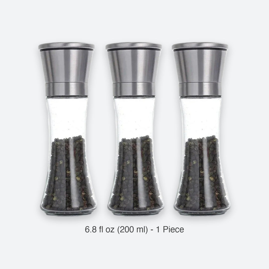 Three clear glass pepper mills with brushed silver metal tops, shown side by side on a light gray background with the text '6.8 fl oz (200 ml) - 1 Piece' below.