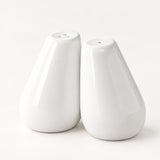 A pair of glossy white teardrop-shaped salt and pepper shakers on a seamless white background.