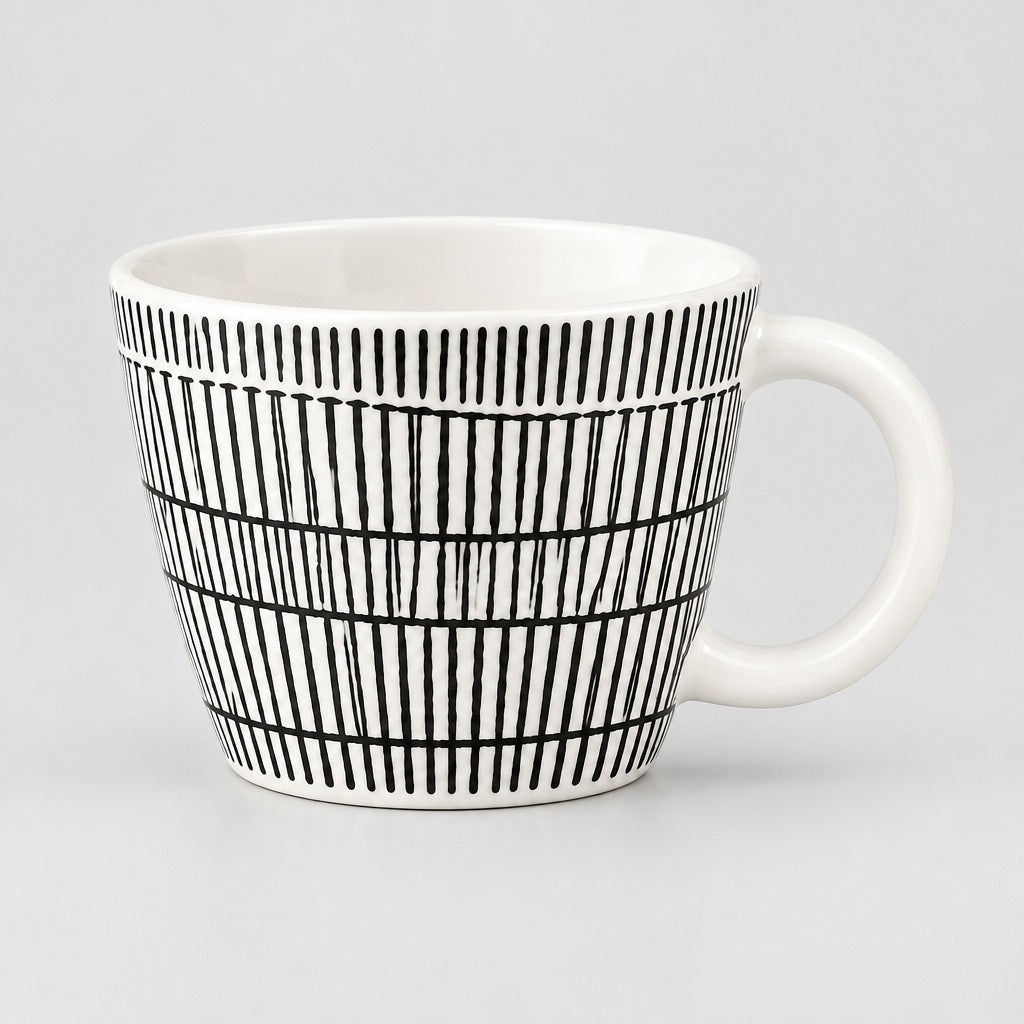 A white ceramic mug with a black hand-drawn vertical stripe pattern, shown against a neutral light gray background.
