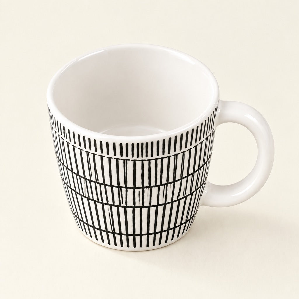 A white ceramic mug with a black vertical stripe grid pattern on the exterior, shown on a light cream background.