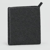 A dark charcoal gray textured cleaning sponge or scrubber with a small loop handle on the top right, shown on a clean light gray background.