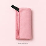 A folded light pink towel or blanket with a black fabric loop, shown on a solid pale pink background with a size measurement printed below.