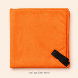 An orange folded microfiber cleaning cloth with a black strap in the bottom right corner, displayed on a light beige background with a size measurement text overlay at the bottom.