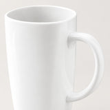 A close-up of a glossy white ceramic mug with a curved handle, shown against a plain light beige background.