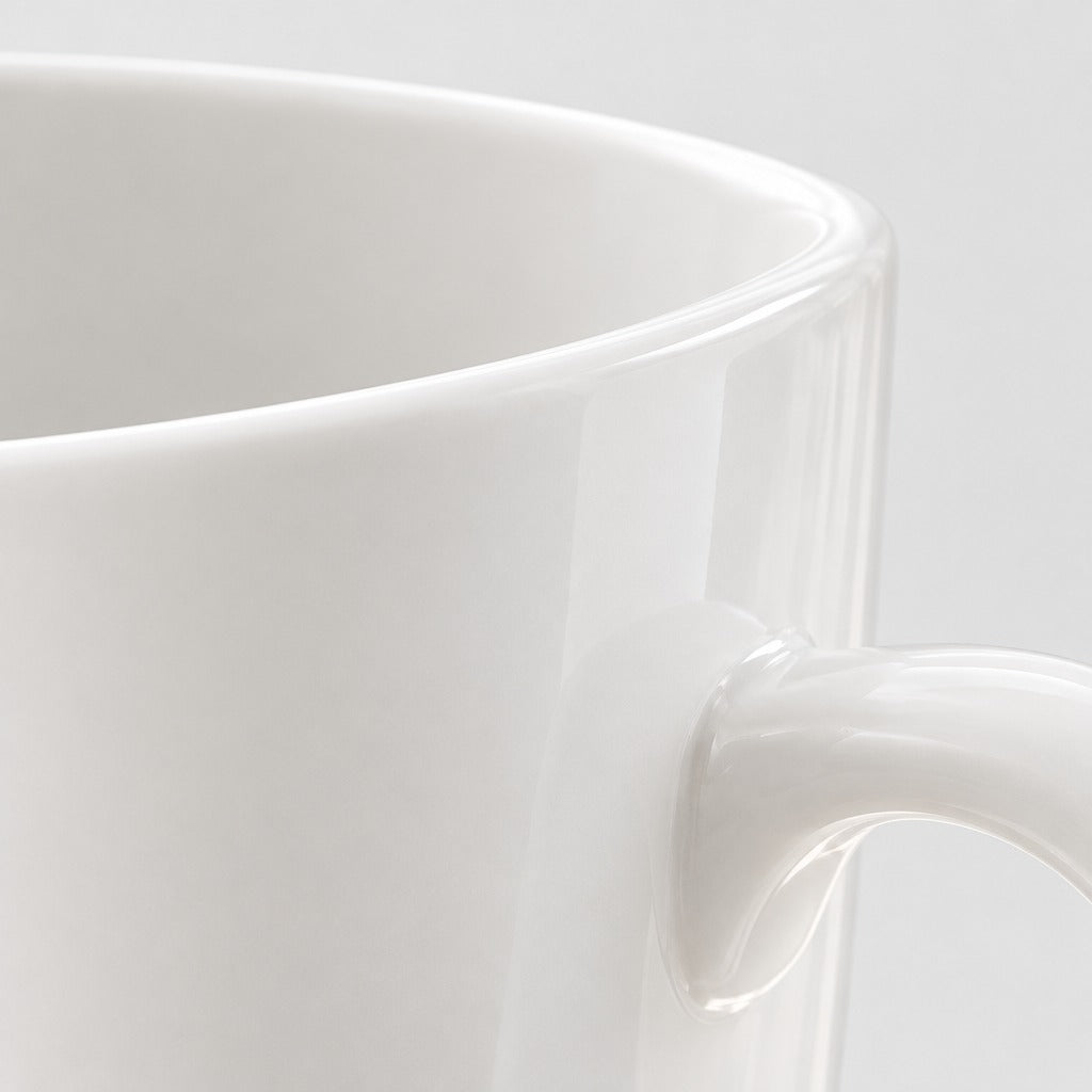 Close-up of a glossy white ceramic mug showing the rim and handle against a light gray background.