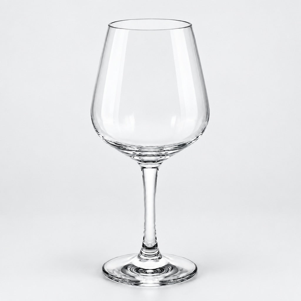A clear glass wine glass with a wide bowl, slender stem, and flat circular base, photographed on a light gray studio background.