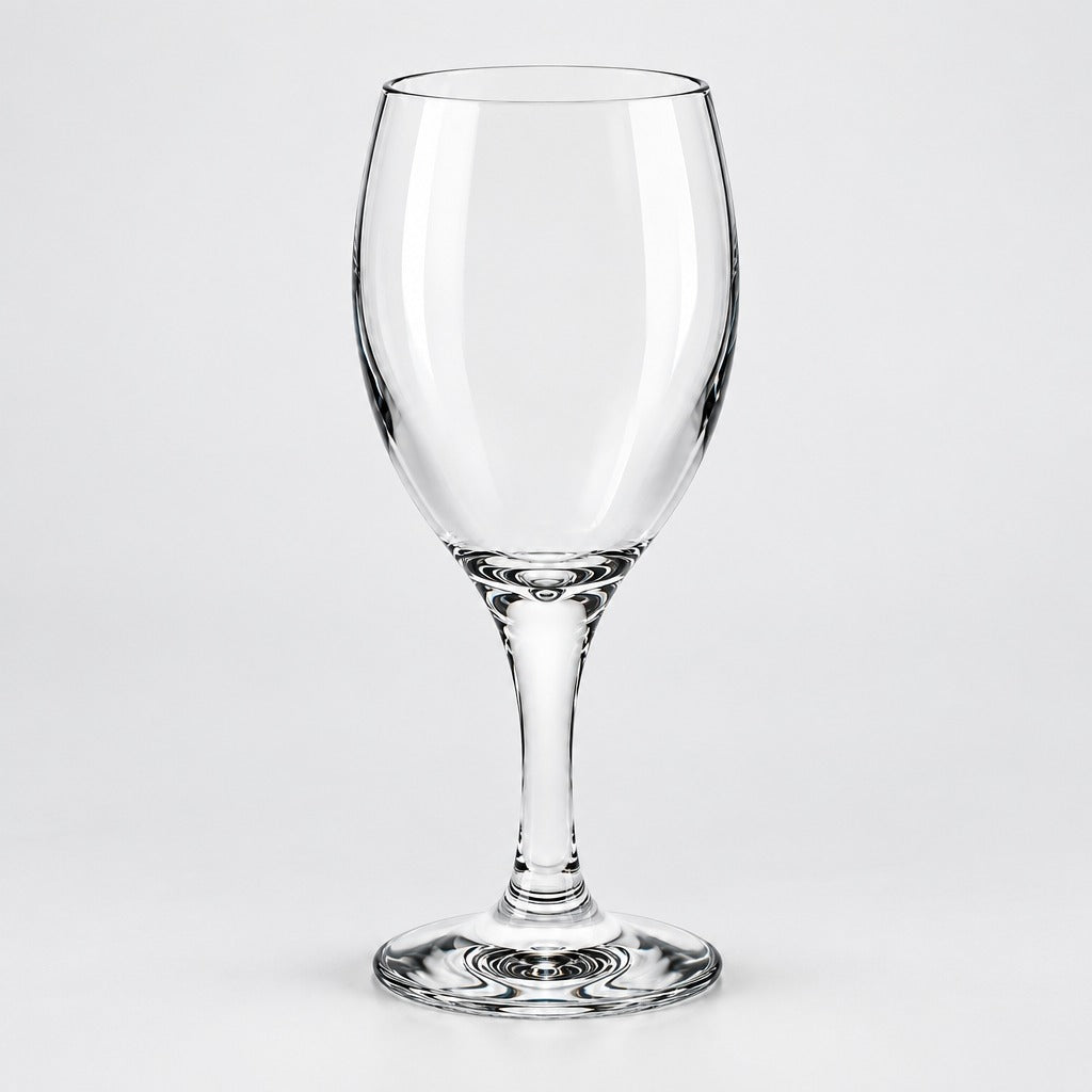 A clear glass wine glass with a wide bowl, a slender stem, and a flat circular base, photographed against a light gray studio background.