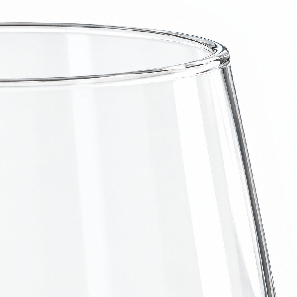 Close-up of a clear glass tumbler showing the rim and side profile against a white background.