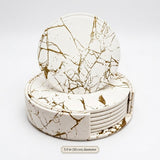 A set of round coasters with a white faux-leather surface and a metallic gold marble vein pattern, stacked inside a matching circular holder. A small text label at the bottom reads '3.