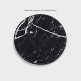 A round black marble coaster with white veining, shown on a light gray background with a text overlay indicating its diameter is approximately 3.9 inches (10 cm).