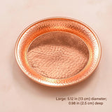 A round hammered copper tray with a textured, metallic finish, shown on a light beige background with text indicating its dimensions.