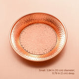 A small hammered metal tray in a warm copper or rose-gold tone, photographed from above on a matching pink-beige background. Text at the bottom reads: Small: 3.