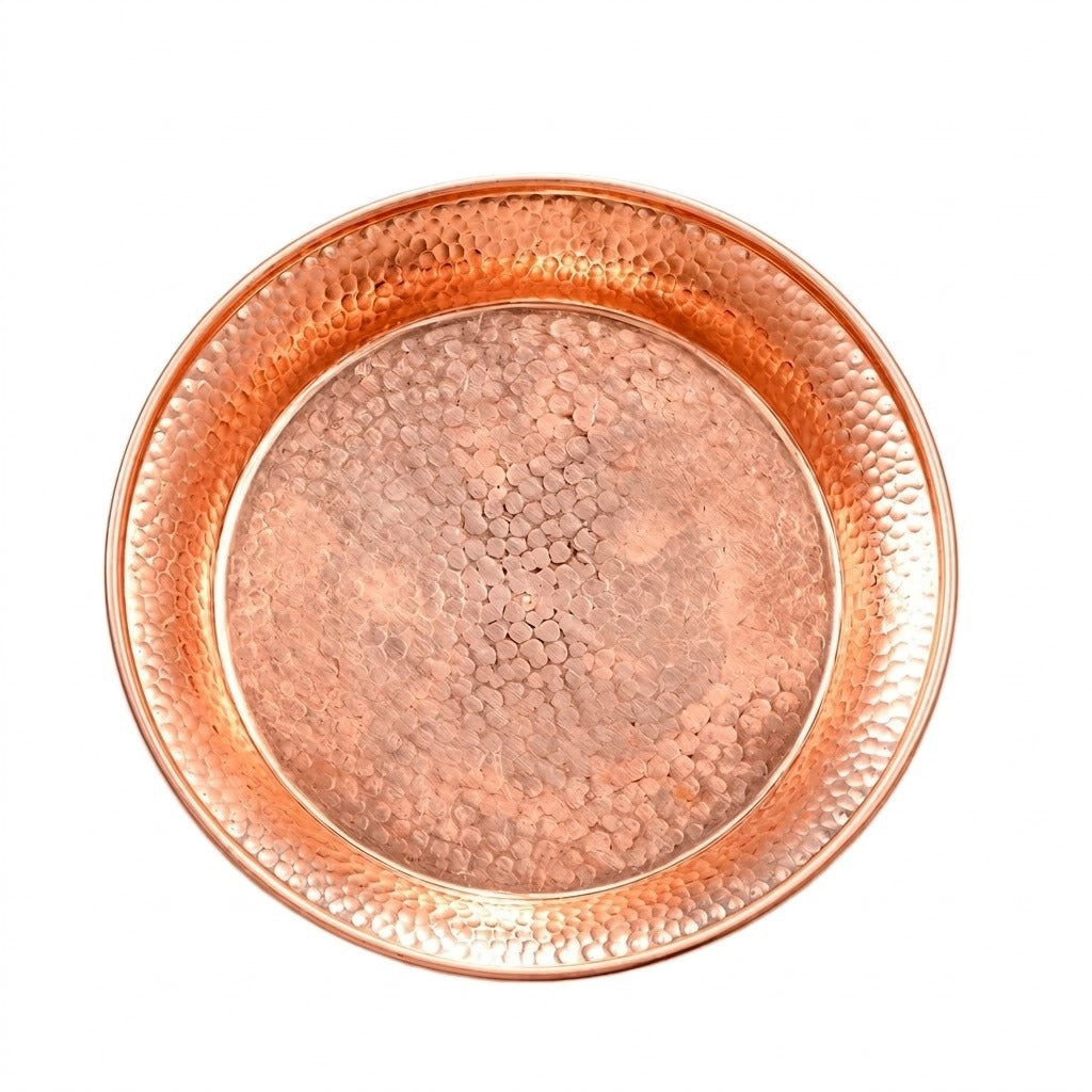 A round hammered copper tray or shallow dish with a textured metallic finish, shown from a top-down view on a plain white background.