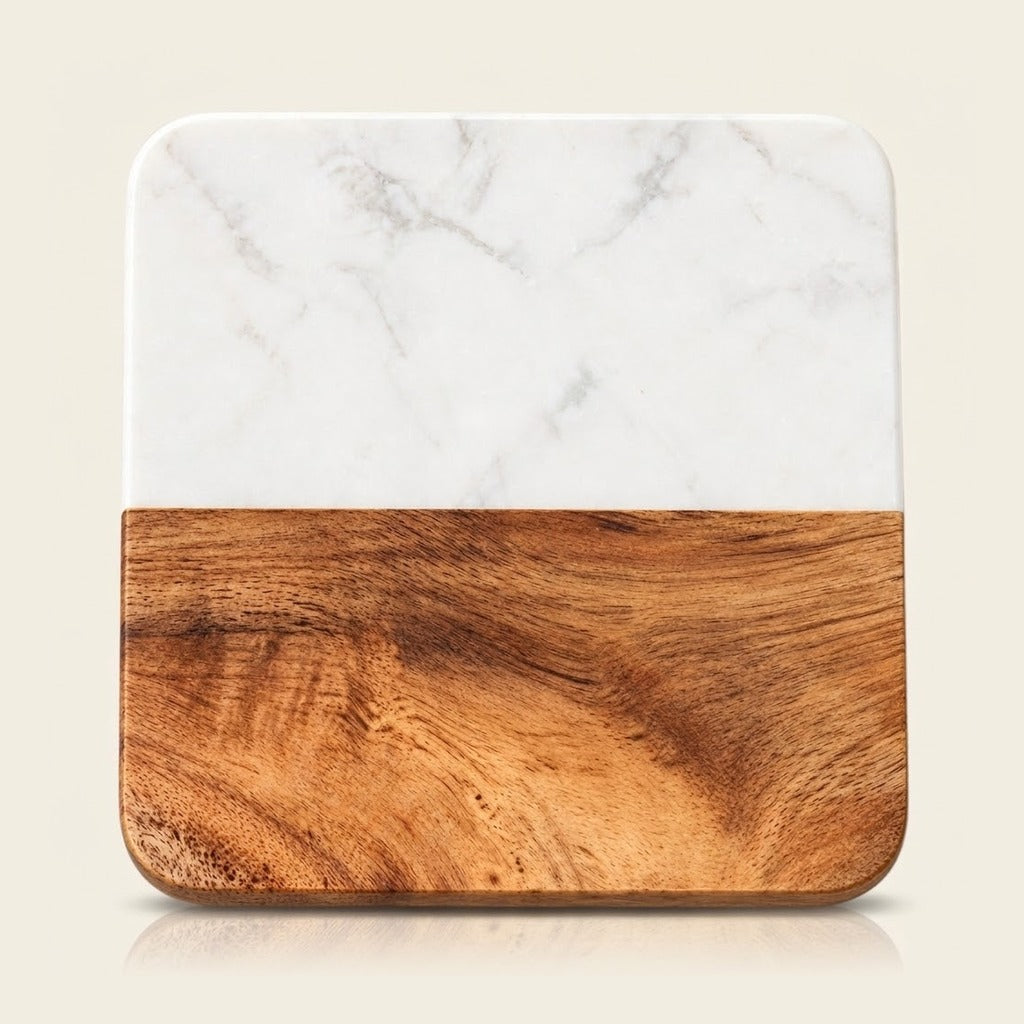 A square serving board or tray with rounded corners, featuring a white marble top half and a warm brown wood grain bottom half, shown on a light beige background.