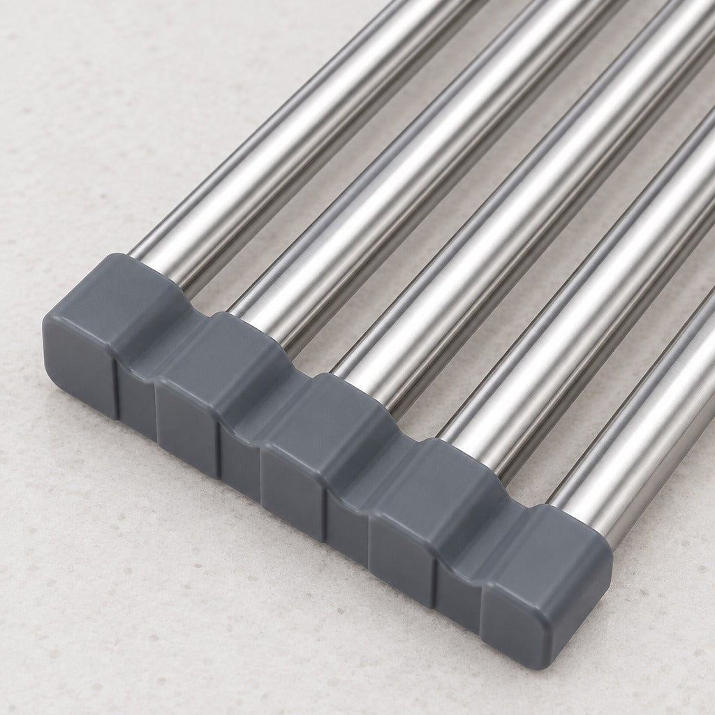 Close-up of a set of stainless steel rod handles with dark gray square end caps, arranged diagonally on a light textured surface.