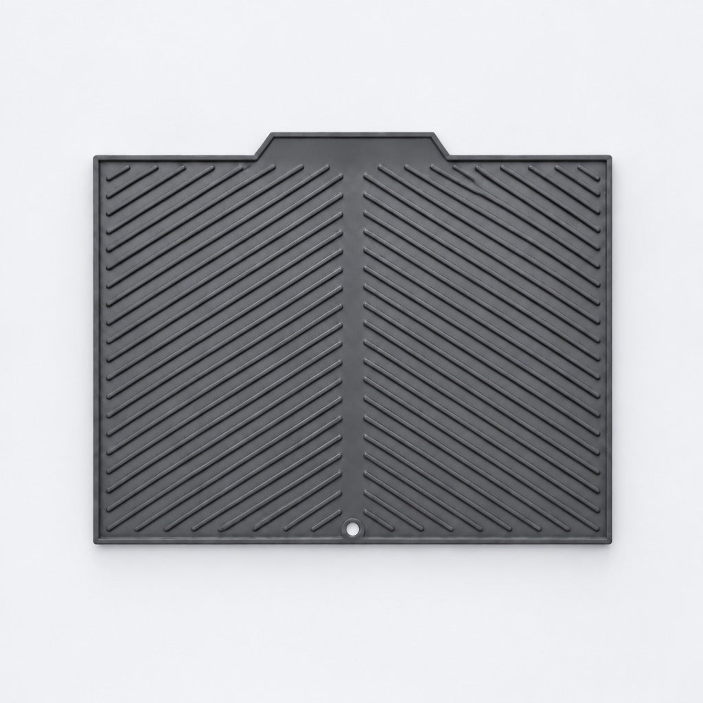 A black rubber or plastic protective cover with a textured diagonal ribbed pattern and a small circular hole near the bottom center, shown flat against a light gray background.