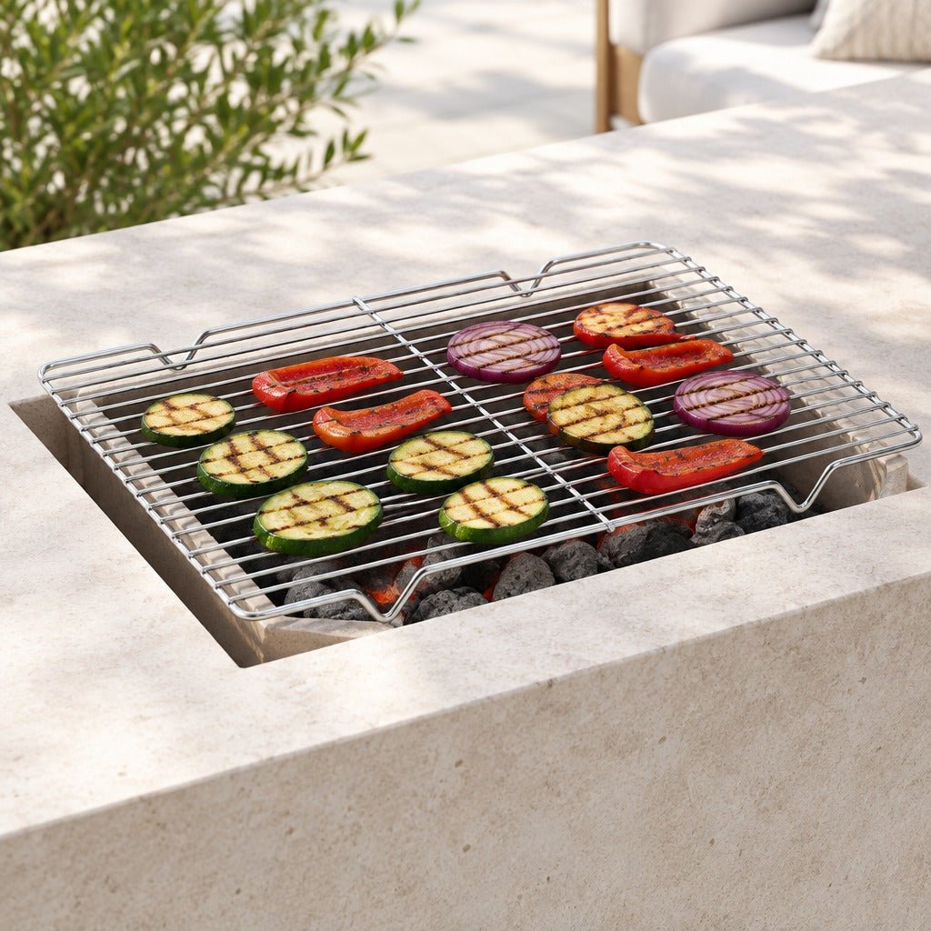 A rectangular metal grill grate sits over a built-in stone fire pit with charcoal and grilled vegetables, shown in an outdoor patio setting.