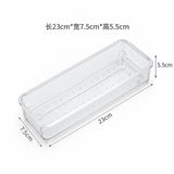 A clear plastic rectangular storage container with dimension labels showing 23cm length, 7.5cm width, and 5.