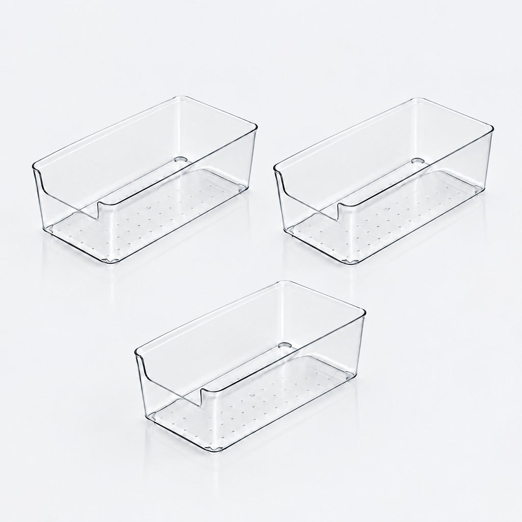 Three clear rectangular storage bins with lowered front openings and dotted bases arranged separately on a white background.
