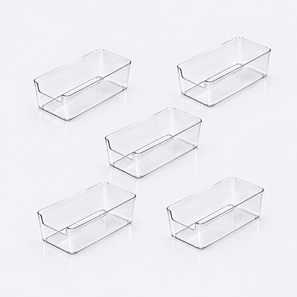 Five clear plastic rectangular storage bins arranged on a light gray reflective surface.