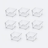 Eight clear plastic organizer bins arranged in two rows on a clean white background.