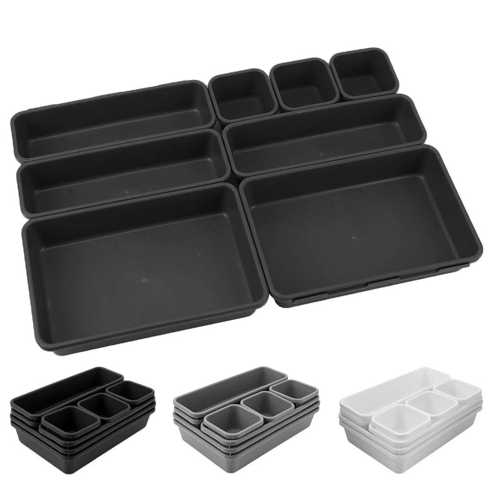 Set of black and gray plastic trays on a white background