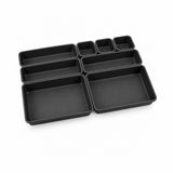 A set of black rectangular compartment organizers in various sizes, arranged on a plain white background.