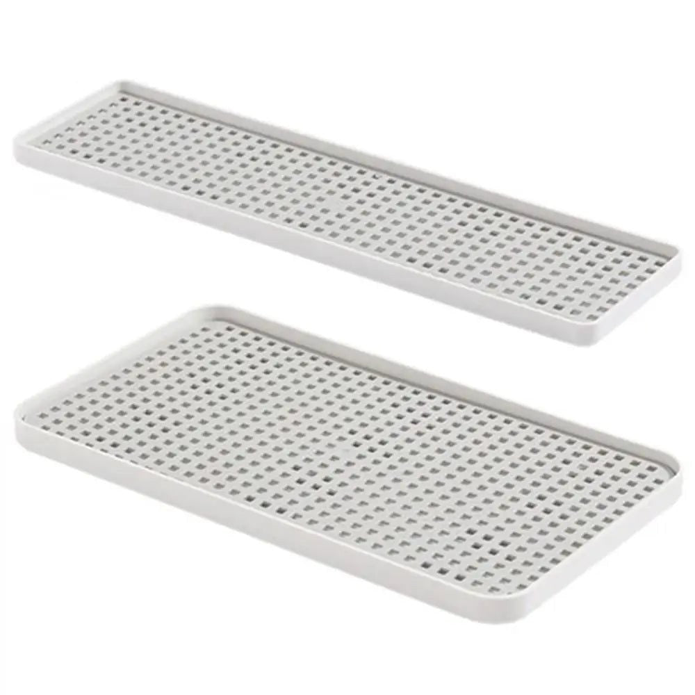 Two white rectangular plastic trays with a perforated grid pattern, shown on a plain white background.