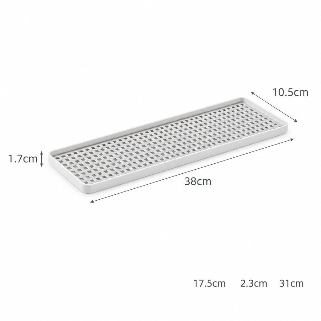 A rectangular white metal drain tray with a perforated grid pattern, showing dimension annotations of 38cm length, 10.5cm width, 1.