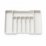 A white plastic organizer tray with five vertical divider slots and a top handle, shown from a top-down view on a white background.