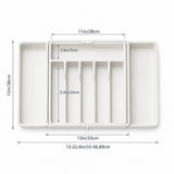 White plastic organizer tray with multiple compartments, shown from above with overlaid dimension labels and arrows indicating measurements.