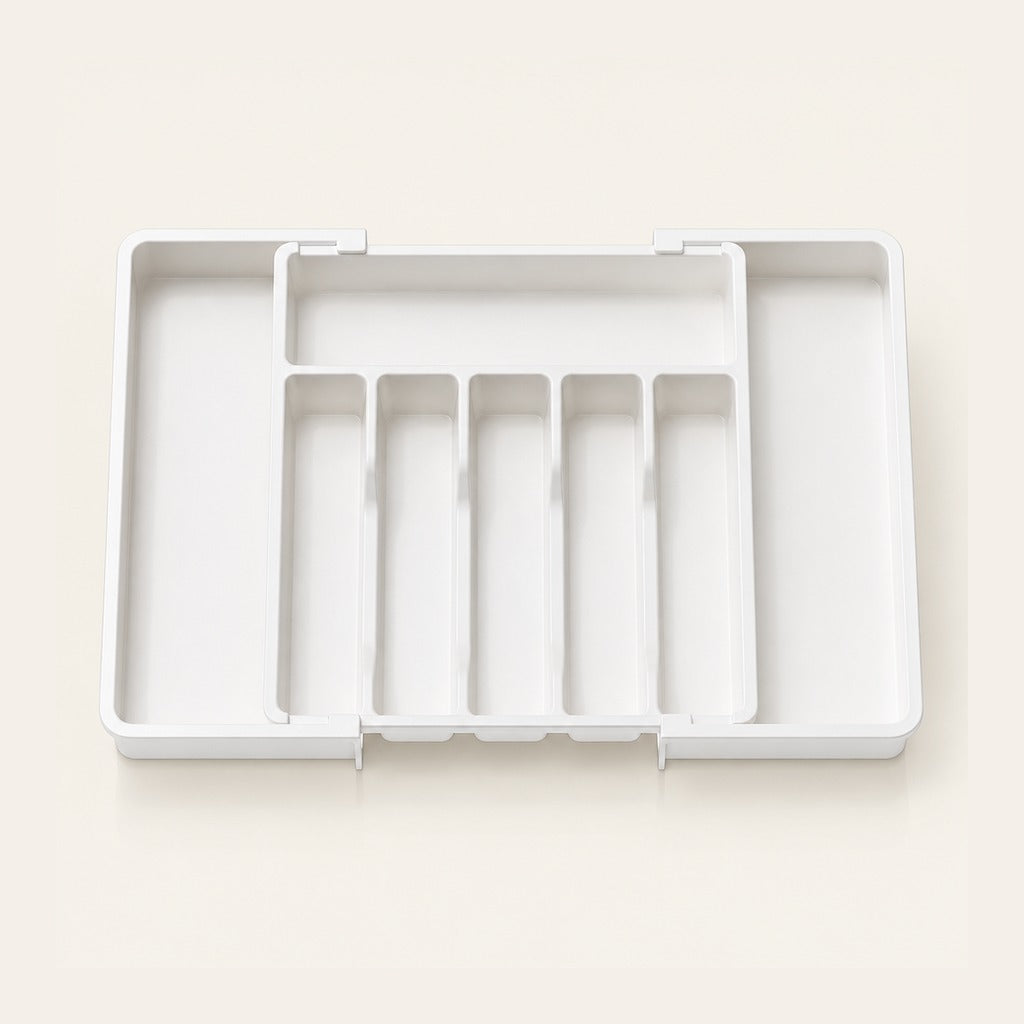 A white plastic multi-compartment organizer tray with five vertical slots, shown open on a light beige background.