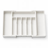 A white plastic organizer tray with multiple compartments, shown from a top-down view on a clean white background.