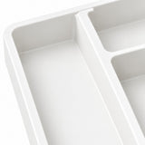 Close-up of a white plastic organizer tray with multiple compartments, showing the smooth matte finish and clean edges against a white background.