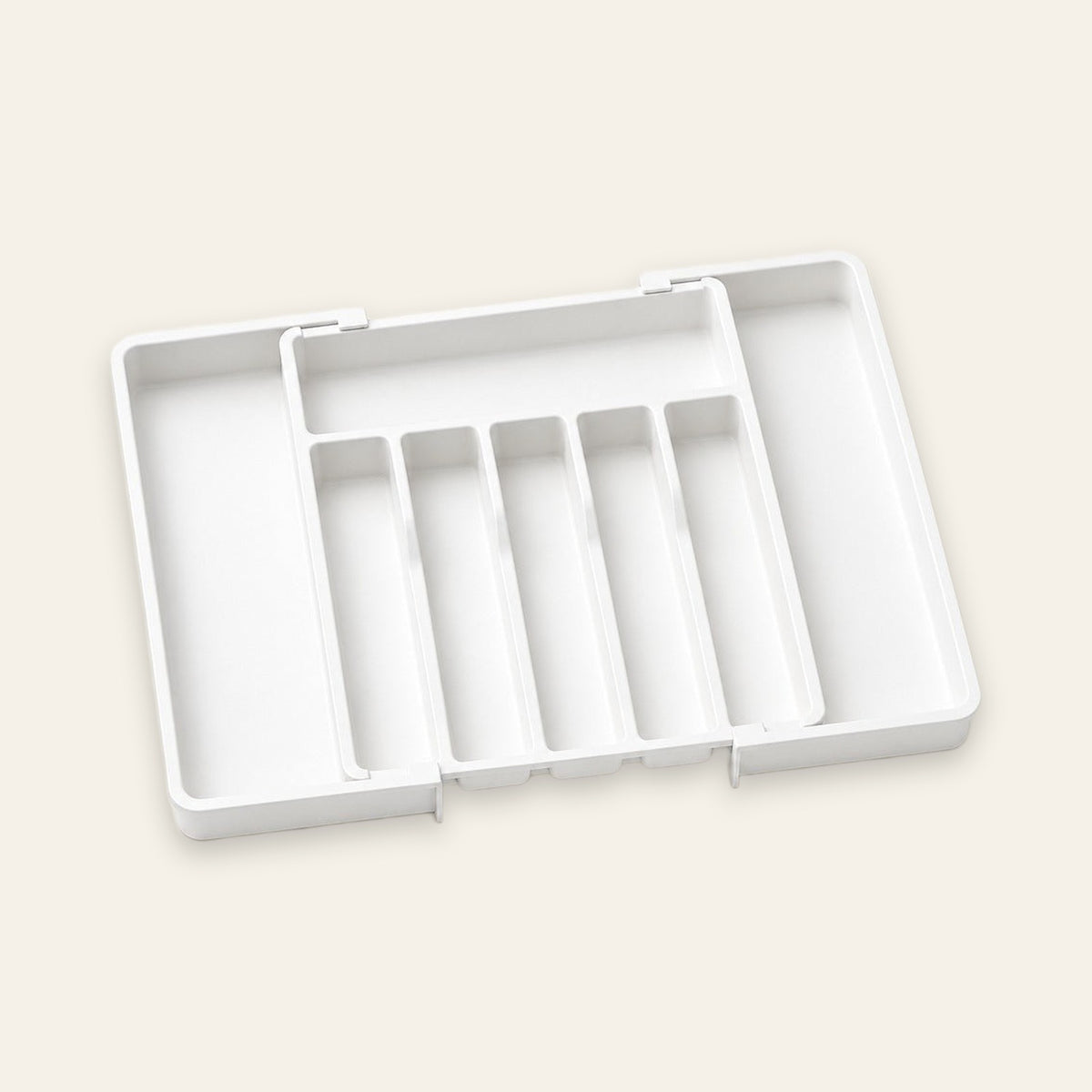 A white plastic organizer tray with five vertical compartments, shown open on a light beige background.