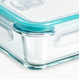 Clear glass food storage container with a translucent lid and bright aqua silicone seal, shown on a clean white background.