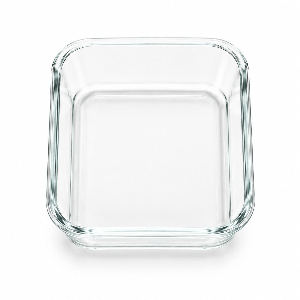 A clear glass rectangular baking dish with rounded corners, shown from a top-down perspective on a white background.