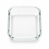A clear glass rectangular baking dish with rounded corners, shown from a top-down perspective on a white background.