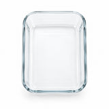 A clear rectangular glass baking dish with rounded corners and thick walls, shown from a top-down perspective on a white background.