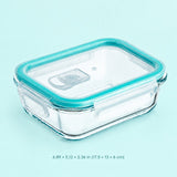 Clear glass rectangular storage container with a translucent teal lid and matching rim, shown on a light aqua background with size text below.