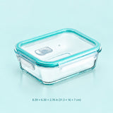 A rectangular clear glass storage container with a translucent aqua blue lid and matching rim, shown on a light blue background with size text below reading 8.39 x 6.