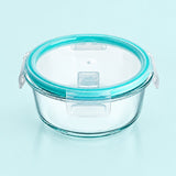 Clear glass storage container with a translucent aqua blue rim and matching clear plastic latch lid, shown on a light blue background.