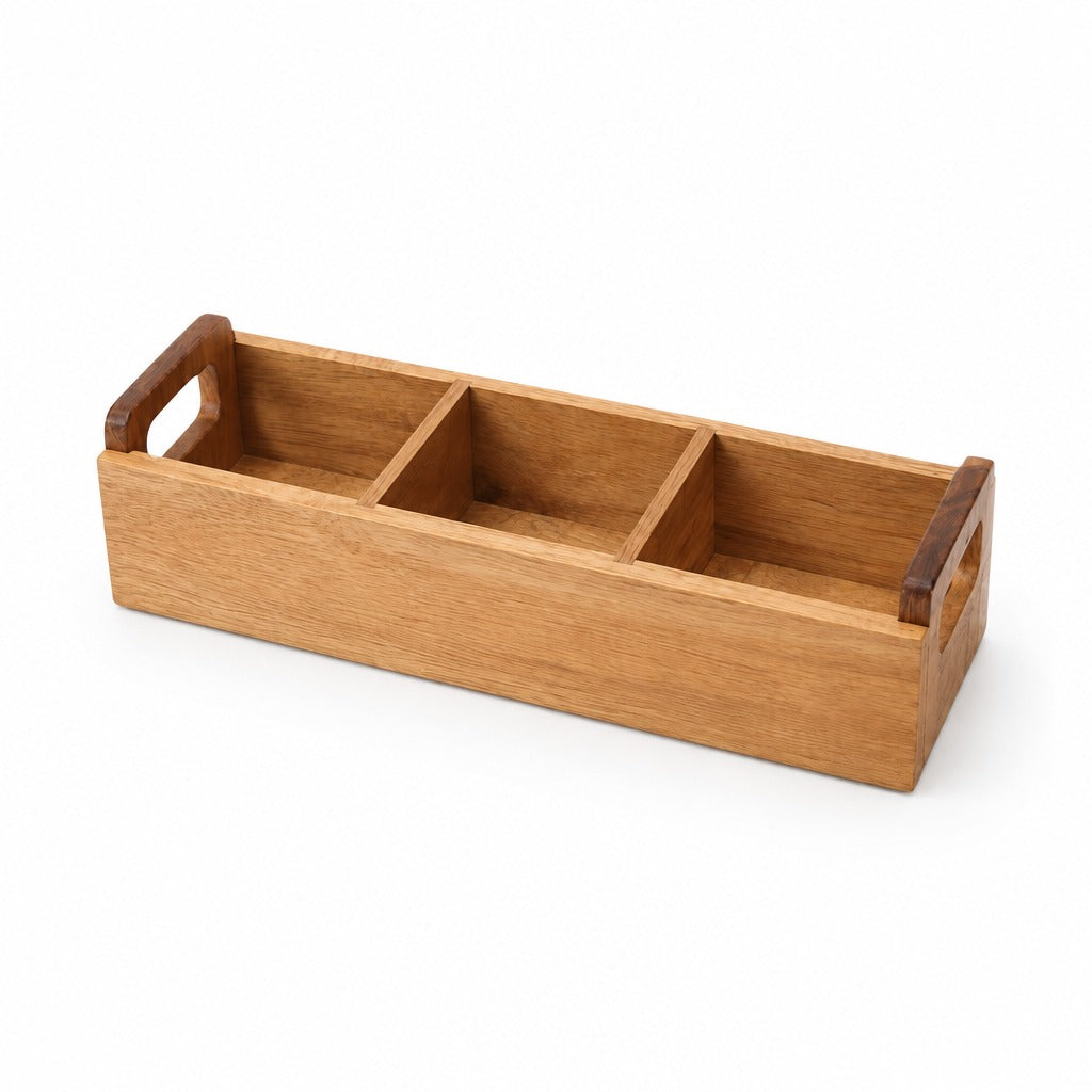 A rectangular wooden organizer tray with three compartments and integrated handles on the ends, shown on a clean white background.