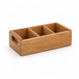 A wooden organizer tray holding multiple small beige tea bags or coffee bags, placed on a wooden table in a warm indoor setting with a plant and a cup nearby.