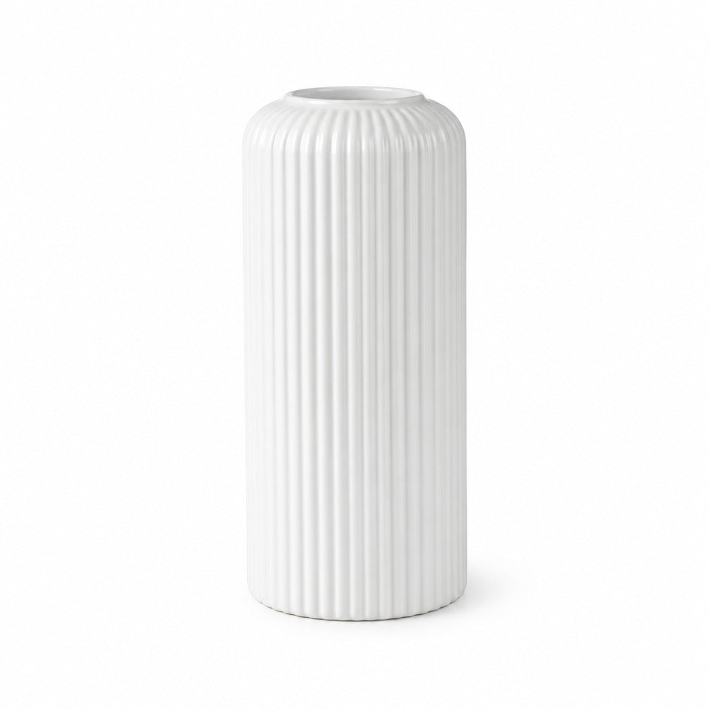 A white ceramic vase with a ribbed, fluted texture, standing upright against a seamless white background.