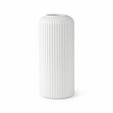 A white ceramic vase with a ribbed, fluted texture, standing upright against a seamless white background.