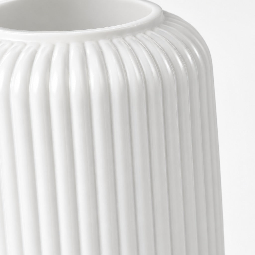 Close-up of a white ribbed ceramic vase with a flared rim, shown against a plain white background.