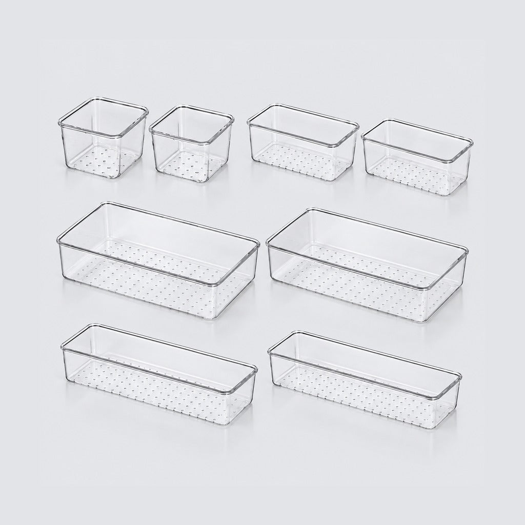 Set of eight clear plastic organizer bins in various rectangular sizes with perforated bottoms, arranged on a light gray background.